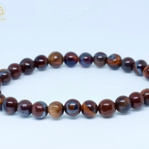 Bracelet boule Œil de Taureau en pierre naturelle, bijou de lithothérapie favorisant la confiance en soi, l'ancrage, la protection et la motivation.